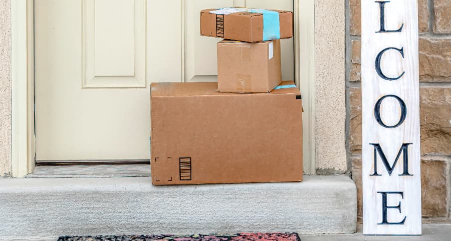 Packages on the doorstep of a home with a welcome sign in Beaumont